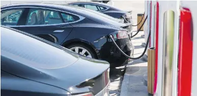  ?? TORE MEEK/THE ASSOCIATED PRESS FILES ?? Carbon taxes have the highest impact on lower-income earners, who are less able to respond to higher fuel prices by buying hybrid and electric cars, like these Teslas.