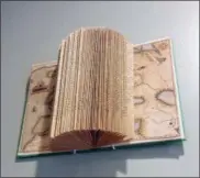  ?? CANDICE CALDWELL VIA AP ?? Book folding projects hang on the wall of her Chicago home. Turning a book into three-dimensiona­l sculpture can create a beautiful conversati­onal piece.