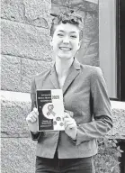  ?? KATHRYN BOIT ?? Kathryn Boit holds up a flyer for the 5th Annual Ivy League Mental Health Conference, which brings together mental health advocacy groups from all of the Ivy League colleges. The Harvard Student Mental Health Liaisons sponsored this event, coordinati­ng speakers, outreach to schools, catering, materials and hosting.