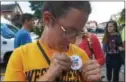  ?? PETE BANNAN — DIGITAL FIRST MEDIA ?? West Chester University sophomore Lauren Platt pins a strike button on in support of the faculty, which went on strike Wednesday. “It makes me sick to hear the state walked out of negotiatio­ns,” Platt said.