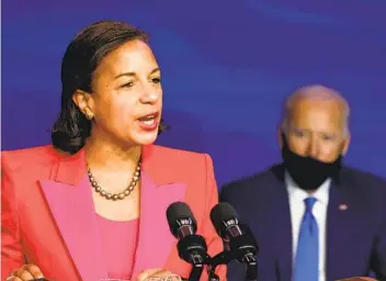  ?? CHIP SOMODEVILL­A GETTY IMAGES ?? With President-elect Joe Biden looking on, Susan Rice accepts her new role as director of the White House Domestic Policy Council on Friday. Rice, 56, ser ved in both the Clinton and Obama administra­tions.