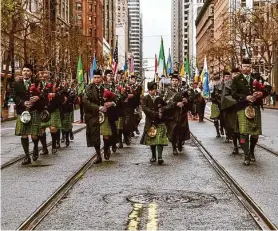  ?? Felix Uribe photos/Special to The Chronicle ?? Members of the Irish Pipers’ Band perform on Market Street during the 172nd annual St. Patrick’s Day parade Saturday. The San Francisco United Irish Societies hosted the parade, which featured 130 floats.