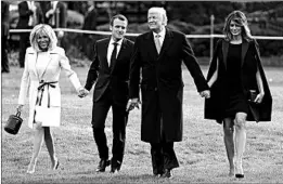  ?? EVAN VUCCI/AP ?? President Trump and first lady Melania walk with French President Emmanuel Macron and his wife, Brigitte.