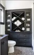  ?? ANGIE SECKINGER, THE WASHINGTON POST ?? Take advantage of the vertical space in a small bathroom, says designer Shazalynn Cavin-Winfrey. A tall cabinet or a medicine cabinet over the toilet can make a big difference.