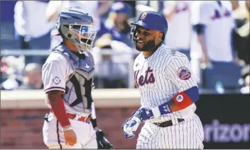  ?? JOHN MINCHILLO/AP ?? NEW YORK METS’ ROBINSON CANO celebrates after hitting a solo home run off Arizona Diamondbac­ks starting pitcher Zach Davies in the fourth inning of a game on April 15 in New York.