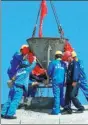  ?? CHEN JUNFENG / XINHUA ?? Workers pour cement to seal the roof of a building in the China-Belarus Industrial Park in June.