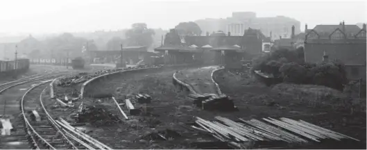  ?? H C Casserley ?? Chesterfie­ld Town Hall was completed in 1938 and is prominent on the horizon, while all is quiet in the foreground at Market Place station on Saturday, 7 June 1956. The former passenger platforms are now devoid of track but the goods yard was still the recipient of a daily goods train, usually worked by a former GCR ‘Pom-Pom’ ‘J11’ class 0-6-0. By this date the LD&ECR main line from Markham Junction to Arkwright Town Junction had been out of use for over a year so this train would start from Staveley and run along the GCR main line to Duckmanton North Junction where the link to the LD&ECR was gained, and would then reverse at Arkwright Town Junction to reach Chesterfie­ld. After Chesterfie­ld (Central) goods was altered to cope with the extra traffic, Market Place closed from 4 March 1957.