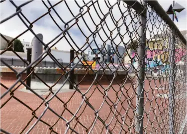  ?? Photos by Carl Nolte / The Chronicle ?? The BART plaza at 24th and Mission streets has been fenced off to keep out vendors selling stolen items.