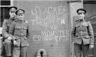  ??  ?? Canadian soldiers in Toronto send a message to men who won’t volunteer for service, 1917.