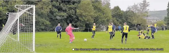  ??  ?? Bro Goronwy striker Carwyn Williams is denied by Llanllyfni’s John Gould