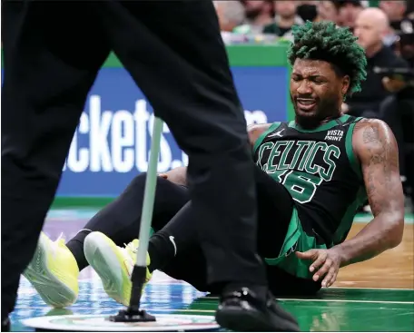  ?? NANCY LANE PHOTOS / HERALD STAFF FILE ?? SIDELINED: Celtics guard Marcus Smart winces after getting knocked to the floor during the third quarter of Game 1 of their second-round playoff series against the Bucks at TD Garden on Sunday.