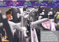  ??  ?? A currency dealer monitors exchange rates in a trading room at the KEB Hana Bank in Seoul yesterday as South Korean shares fell 1.19%