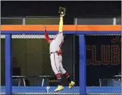  ?? FRANK FRANKLIN II – THE ASSOCIATED PRESS ?? Braves right fielder Ronald Acuna Jr. leaps to take a homer away from the Mets' Pete Alonso in the first inning Friday.