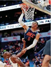  ?? [AP PHOTO] ?? Russell Westbrook misses this dunk over Pelicans center Emeka Okafor, but he didn’t miss many shots Sunday en route to 26 points and a 109-104 Thunder win.