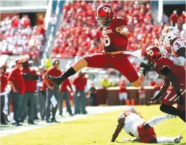  ?? Associated Press ?? ■ In this Oct. 7, 2017, file photo, Oklahoma quarterbac­k Baker Mayfield (6) leaps over Iowa State defensive back De'Monte Ruth, bottom, in the second quarter of an NCAA college football game in Norman, Okla. Mayfield was the number one pick in the NFL...