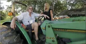  ?? GERRY BROOME — ASSOCIATED PRESS ?? Tom and Heather LaGarde are seen on his tractor at their home near Saxapahaw, N.C., last month.