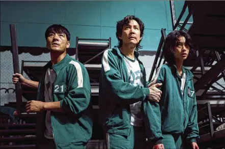  ?? VIA AP YOUNGKYU PARK/NETFLIX ?? South Korean cast members, from left, Park Hae-soo, Lee Jung-jae and Jung Ho-yeon in a scene from “Squid Game.”