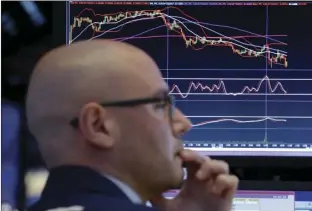  ??  ?? Specialist Mario Picone works at his post on the floor of the New York Stock Exchange on Tuesday. U.S. stocks and the dollar are slipping Tuesday morning after the latest Republican health care bill failed in the Senate. AP PHOTO/RICHARD DREW