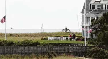  ?? Charles Krupa / Associated Press ?? American flags fly at half-staff as people gather at the Kennedy compound Friday after the death of Saoirse Kennedy Hill the previous night. Hill was a granddaugh­ter of the late Robert F. Kennedy.