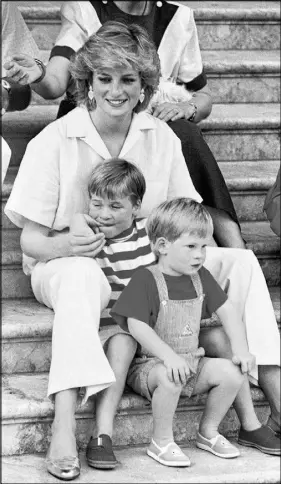  ?? AP file Photo ?? In this 1987 photo, Britain’s Diana, Princess of Wales smiles as she sits with her sons, princes Harry (front) and William, on the steps of the Royal Palace on the island of Mallorca, Spain, where the British Royal family was on holiday with Spanish...