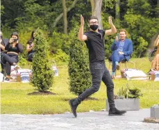  ?? CHARLES SYKES/INVISION ?? Designer Christian Siriano walks the runway following his show during NewYork Fashion Week in Westport, Connecticu­t, on Sept. 17. Siriano invited guests to his Connecticu­t home for a socially distanced runway show with models in masks.