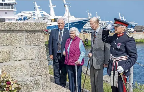  ?? ?? REMEMBRANC­E: The Duke pays his respects with, from left, RNLI chief executive Mark Dowie, Pat Owen, whose husband James Buchan died in the tragedy, and the Lord-Lieutenant of Aberdeensh­ire Alexander Philip Manson.
