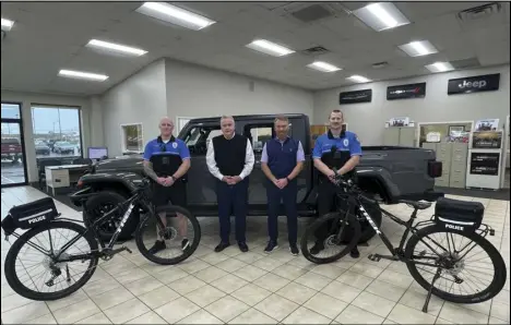  ?? Photo provided ?? St. Marys Chrysler Operations Manager Scott Nuttle, as well as Finance Manager Rob Bechtel, stand with SMPD officers with the mountain bikes they’re donating to the organizati­on. The police department had been looking to replace the current mountain bikes in order to be able to use their bike patrol more often.