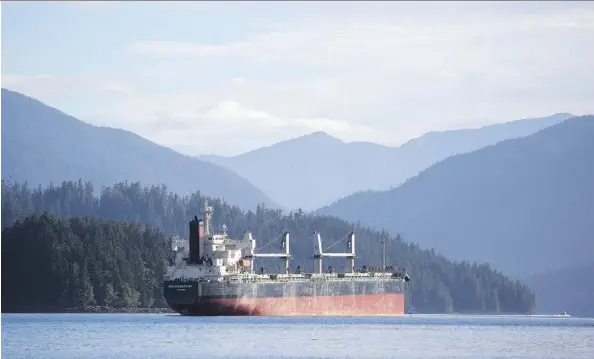  ?? BEN NELMS/BLOOMBERG FILES ?? A bulk carrier sits moored near the port in Prince Rupert, B.C. Vancouver-based Eagle Spirit is working with private landowner Roanan to establish an oil tanker port in the Alaska border town of Hyder. The federal government’s tanker ban stands in the...