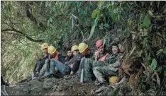  ??  ?? Workers gather and take a rest at regular intervals. The people involved in constructi­on of the Laohuzui Tunnel are mostly from Yunnan, Guizhou and Sichuan provinces. They have been working far away from home for a long time.