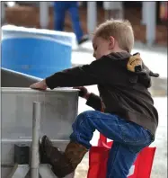  ?? RECORDER PHOTO BY ALEXIS ESPINOZA ?? A future farmer investigat­es the latest dairy troughs Thursday morning at the World Ag Expo in Tulare.