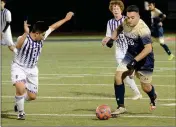  ??  ?? CHANDLER-ARIZONA COLLEGE PREP’S Ricardo Correa (leftd) moves in to try and stop Yuma Catholic’s Frank Flores (26) during the second half of Saturday night’s Arizona Interschol­astic Associatio­n 3A Division Boys Soccer State Championsh­ip game at Williams...