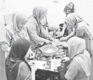  ??  ?? SEBAHAGIAN staf wanita JPP membuat persediaan memasak bubur lambuk.