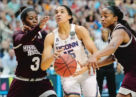  ?? SEAN D. ELLIOT/THE DAY ?? UConn’s Gabby Williams is fouled by Mississipp­i State’s Roshunda Johnson as Breanna Richardson, left, helps on defense during the first half of Friday night’s national semifinal in Dallas. The Huskies were stunned in overtime 66-64.