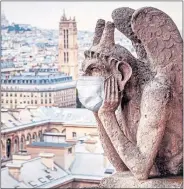  ??  ?? A mask on a gargoyle at Notre Dame, Paris