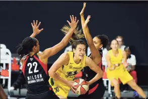  ?? Chris O’Meara / Associated Press ?? Seattle Storm forward Breanna Stewart (30) gets between Las Vegas Aces center A’ja Wilson (22) and forward Cierra Burdick (11) during the second half of Game 3 of the WNBA Finals in Bradenton, Fla., on Oct. 6. The WNBA tipped off its 25th season on Friday night.