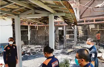  ?? Indonesian Ministry of Justice and Human Rights / Associated Press ?? Police inspect cells after a fire raged through overcrowde­d Tangerang Prison near Indonesia’s capital of Jakarta. The prison — designed to house 900 inmates— has more than 2,000.