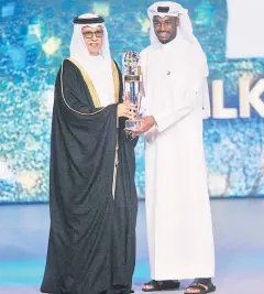  ?? EPA ?? Qatar’s Abdelkarim Hassan, right, receives his award from AFC president Shaikh Salman bin Ebrahim Al Khalifa.