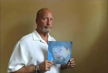  ?? Pittsburgh Post-Gazette ?? Louis F. “Robin” Parrilla, president of the Stowe Township Board of Commission­ers, holds a picture of his late son, Robb Henry Parrilla, 32, on Tuesday at the township municipal building. Robb Parrilla died on April 22 of a fentanyl-related overdose.