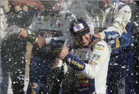  ?? JOHN MUNSON — THE ASSOCIATED PRESS ?? Chase Elliott celebrates his victory with his pit crew after winning a NASCAR Cup Series auto race at Watkins Glen Internatio­nal, Sunday in Watkins Glen, N.Y.