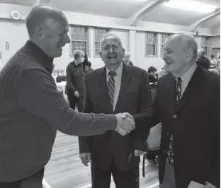  ?? JASON MALLOY ?? Feed Nova Scotia executive director Nick Jennery, left, thanks Leo Dorey, centre, and Bud Little for their years of volunteeri­sm with Fundy Interchurc­h Food Bank.