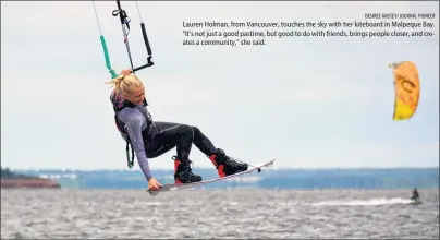  ?? DESIREE ANSTEY/ JOURNAL PIONEER ?? Lauren Holman, from Vancouver, touches the sky with her kiteboard in Malpeque Bay. “It’s not just a good pastime, but good to do with friends, brings people closer, and creates a community,” she said.