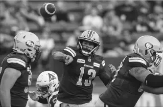  ?? JASON FRANSON THE CANADIAN PRESS ?? Eskimos quarterbac­k Mike Reilly (13) makes a throw against the Montreal Alouettes in first-half CFL action in Edmonton on Saturday. Reilly surpassed 25,000 career passing yards in a 40-24 Eskimos victory.