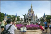  ?? ASSOCIATED PRESS FILE PHOTO ?? People visit the Magic Kingdom Park at Walt Disney World Resort in Lake Buena Vista, Florida, on April 18, 2022.