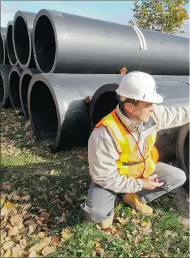  ??  ?? Marc Côté, chief of technical services for Vaudreuil, examines 40-inch