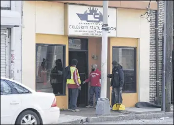  ?? DAVID BARNES PHOTOS / SPECIAL ?? Individual­s sweep up shards of glass outside Celebrity Status Salon, which is on the section of Ralph David Abernathy Boulevard that was blocked by police, after a shooting that took place at The Mall West End in Atlanta on Friday. A shooting took...