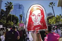  ?? AP PHOTO/CHRIS PIZZELLO ?? A Rubylith printing screen featuring a portrait of Britney Spears is held by Spears supporter Taylor Coppage outside a hearing concerning the pop singer’s conservato­rship at the Stanley Mosk Courthouse on Nov. 12 in Los Angeles. A Los Angeles judge ended the conservato­rship that has controlled Spears’ life and money for nearly 14 years.