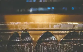  ??  ?? A stream of melted chocolate runs along a piece of equipment at the Mars candy factory in Elizabetht­own, Pa.