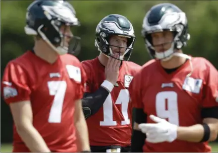  ?? MATT SLOCUM — THE ASSOCIATED PRESS FILE ?? Philadelph­ia Eagles quaterback­s Carson Wentz (11), Nick Foles (9), and Nate Sudfeld (7) walk together during the team’s practice at the NovaCare Complex last week. Wentz was having an MVP season before a torn ACL forced him to the sideline where he watched Foles lead the Eagles to their first Super Bowl victory.