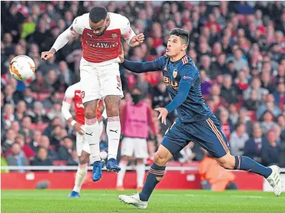  ?? Picture: Getty Images. ?? Alexandre Lacazette heads in his, and Arsenal’s, second goal of the night.