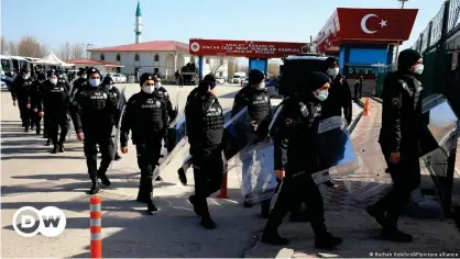  ??  ?? Police officers arrive at Ankara court ahead of the coup trial